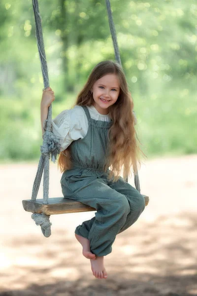 Happy Laughing Kid Girl Long Hair Enjoying Swing Ride Playground — Stockfoto