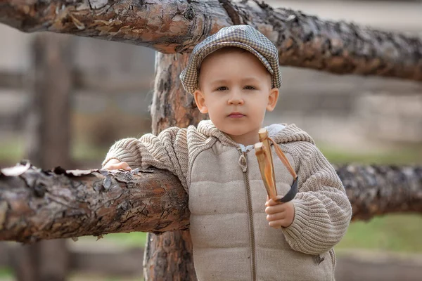 Portrait Bully Boy Kid Slingshot Aims Someone Fence Village Outdoors — Fotografia de Stock