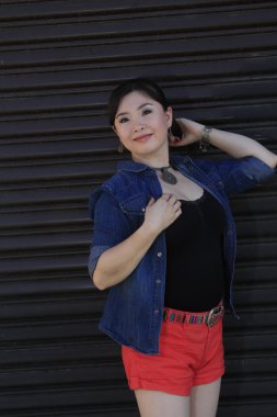 Asya model garaj kapısı önünde poz.