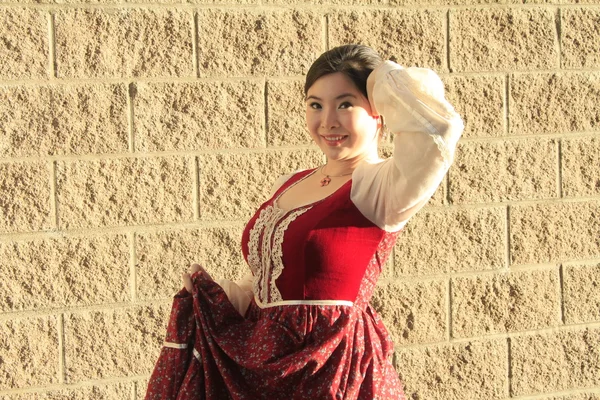 Vintage style barmaid posing near wall — Stock Photo, Image