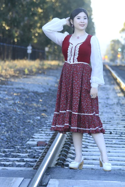 Vintage style barmaid posing on rails — Stock Photo, Image