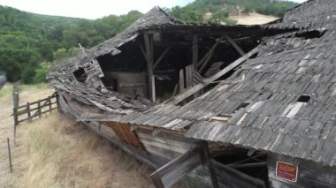 Flying over dilapidated structure, Morgan Hill, California