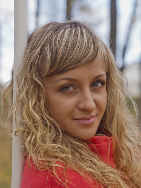 Schönes Mädchen in einem roten Mantel — Stockfoto