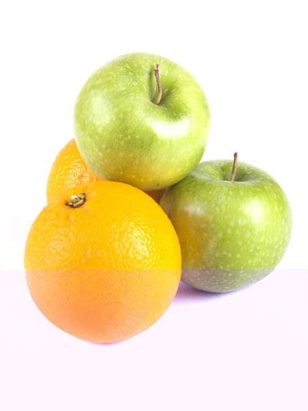 Fruit composition, green apples and oranges — Stock Photo, Image