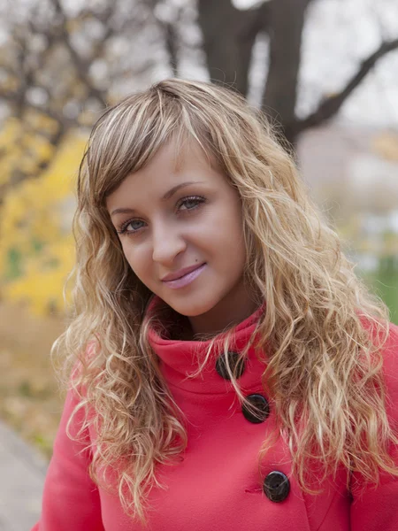 Beautiful girl in a red coat — Stock Photo, Image