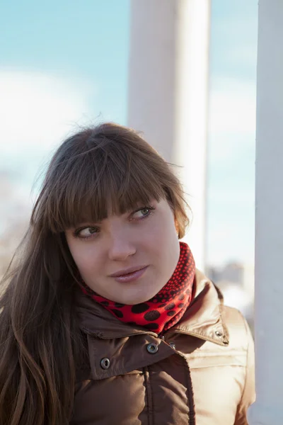 Young girl with dark hair in a brown coat — Stock Photo, Image