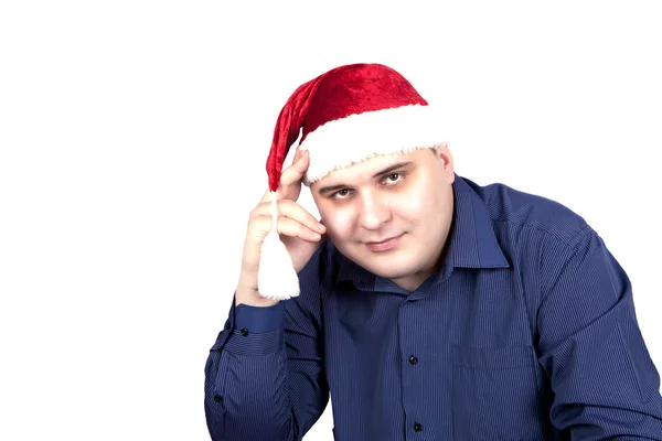 Young man in a blue shirt and in a cap of Santa Claus — Stock Photo, Image