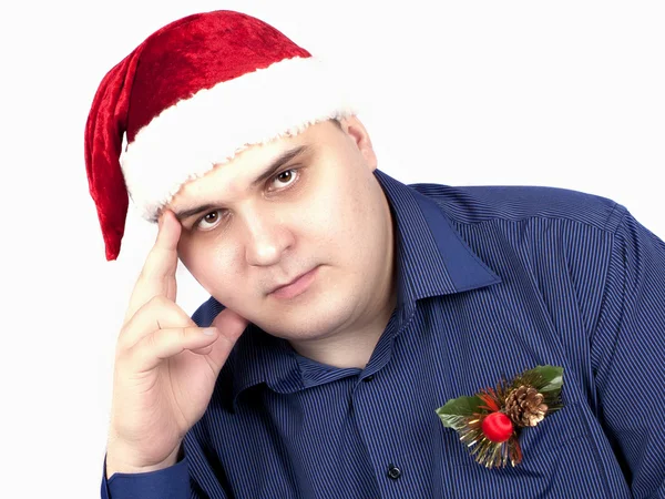 Young man in a blue shirt and in a cap of Santa Claus — Stock Photo, Image