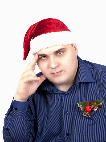 Ung man i en blå skjorta och i en mössa av jultomten — Stockfoto