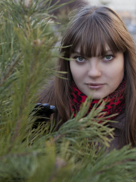 Young girl with dark hair in a brown coat — Stock Photo, Image