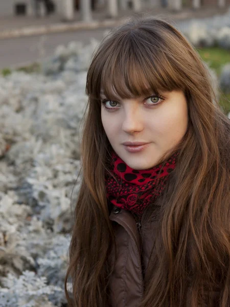 Young girl with dark hair in a brown coat — Stock Photo, Image