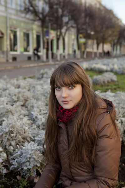 Chica joven con el pelo oscuro en un abrigo marrón —  Fotos de Stock