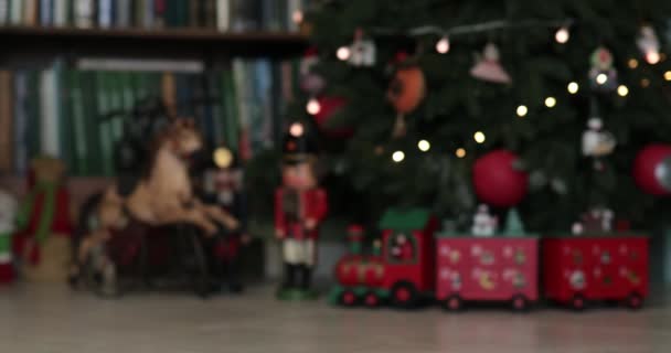 Vintage nutcrackers and advent calendar in shape of train under Christmas tree — Stock Video