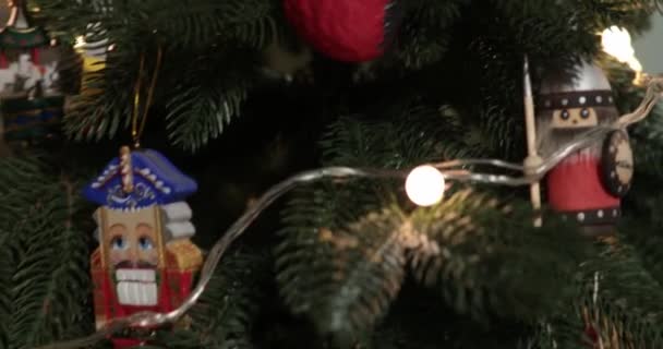 Quebra-nozes vintage e ornamentos de Natal de madeira na árvore de Natal artificial — Vídeo de Stock