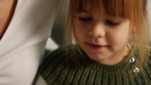 The little girl with mum looks over herbarium — Stock Video