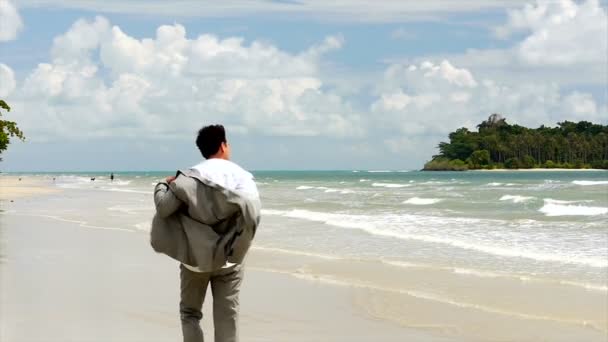 El hombre camina por la playa — Vídeo de stock