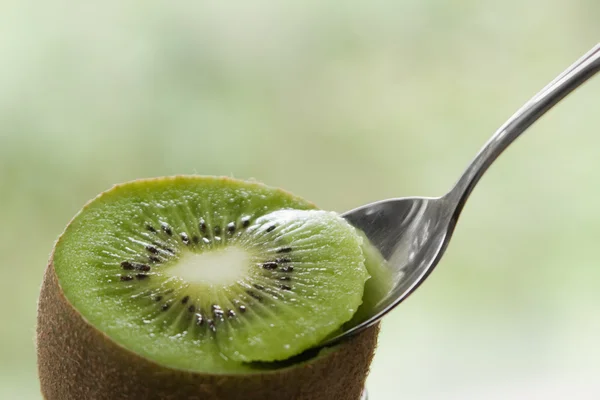 Spoon in kiwi — Stock Photo, Image