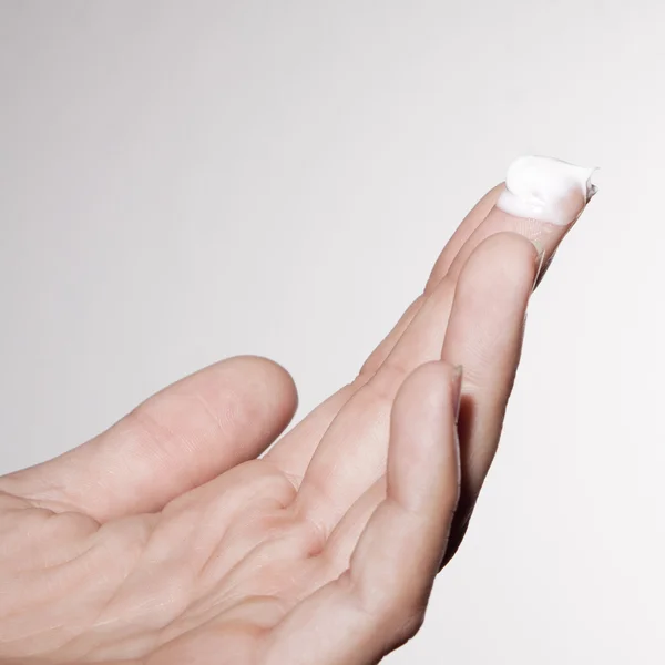 Woman hand using skin cream — Stock Photo, Image