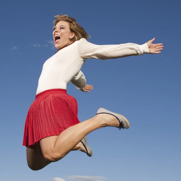 Lucky jumping woman — Stock Photo, Image