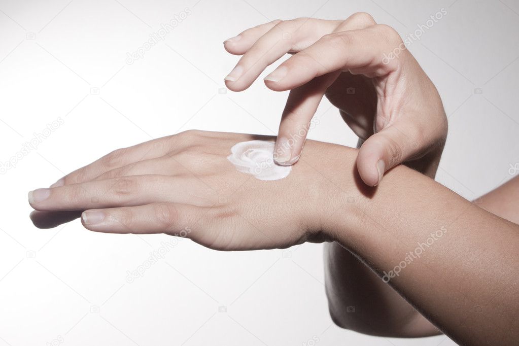 Woman hand using skin cream