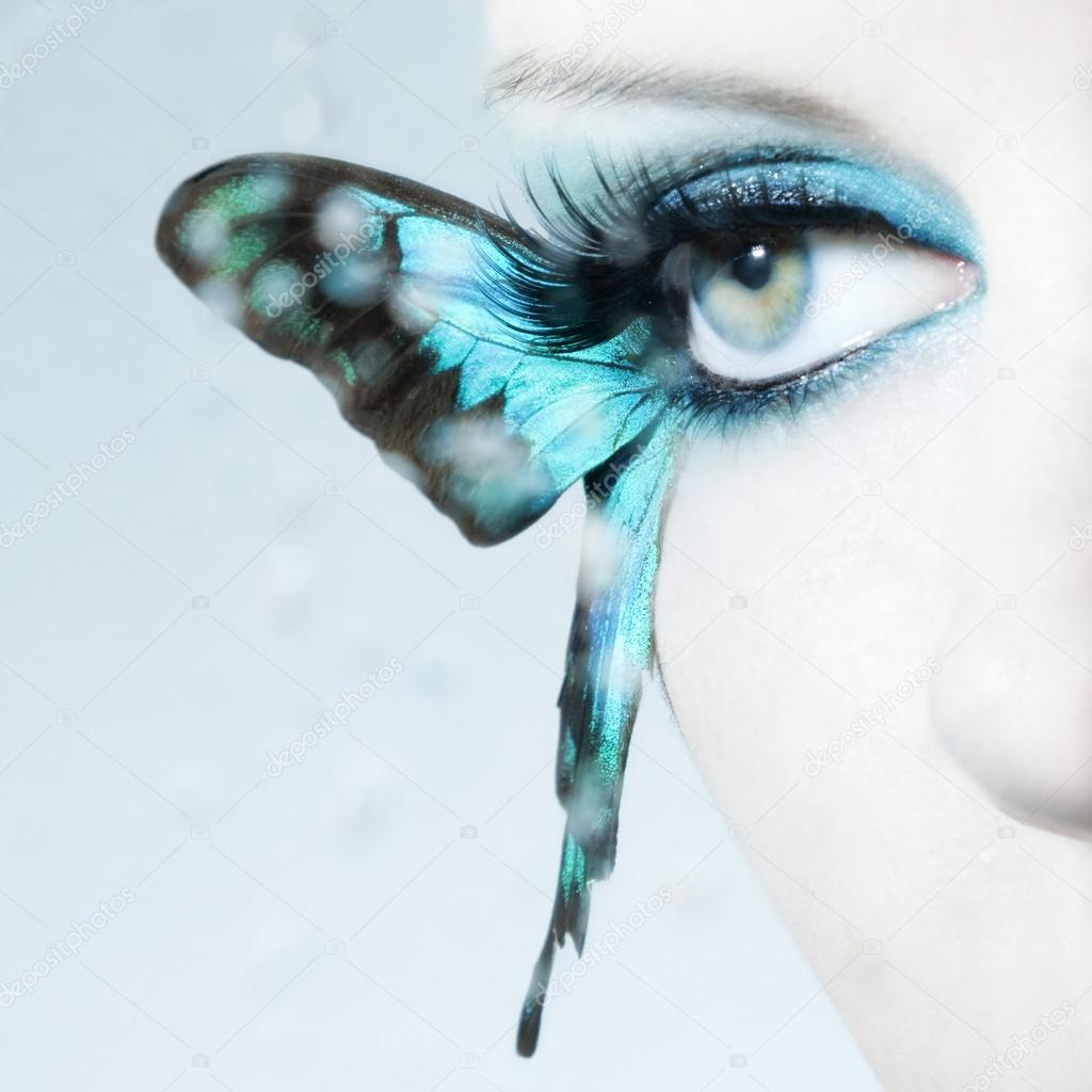 Beautiful woman eye close up with butterfly wings