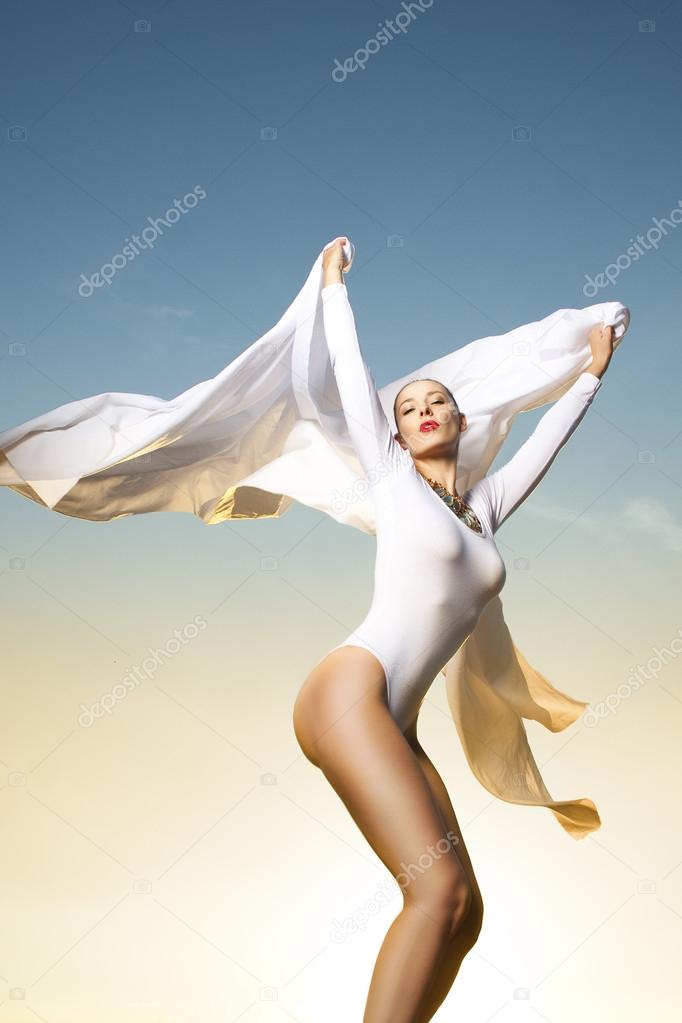 Beautiful woman dancing in sunlight