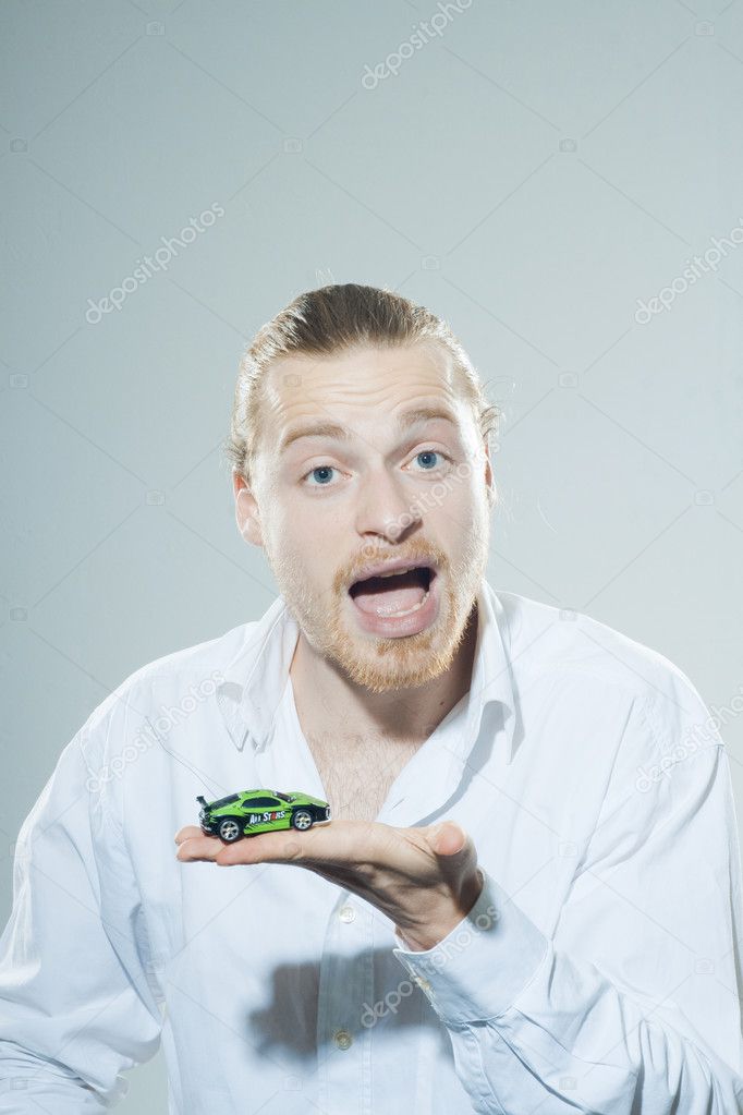 Young man with toy car