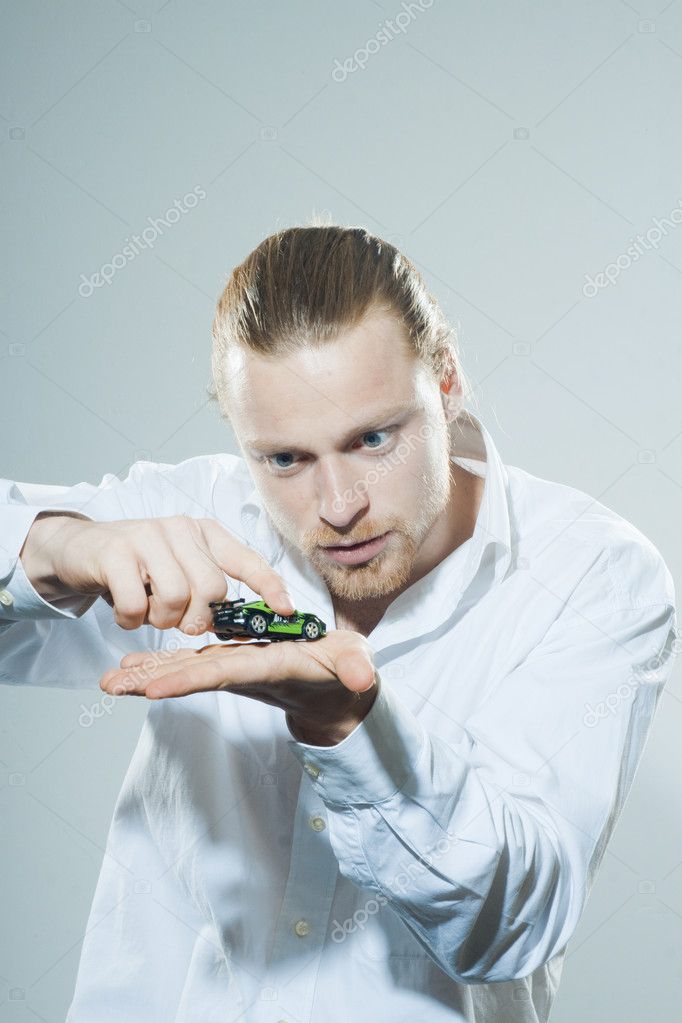 Young man with toy car