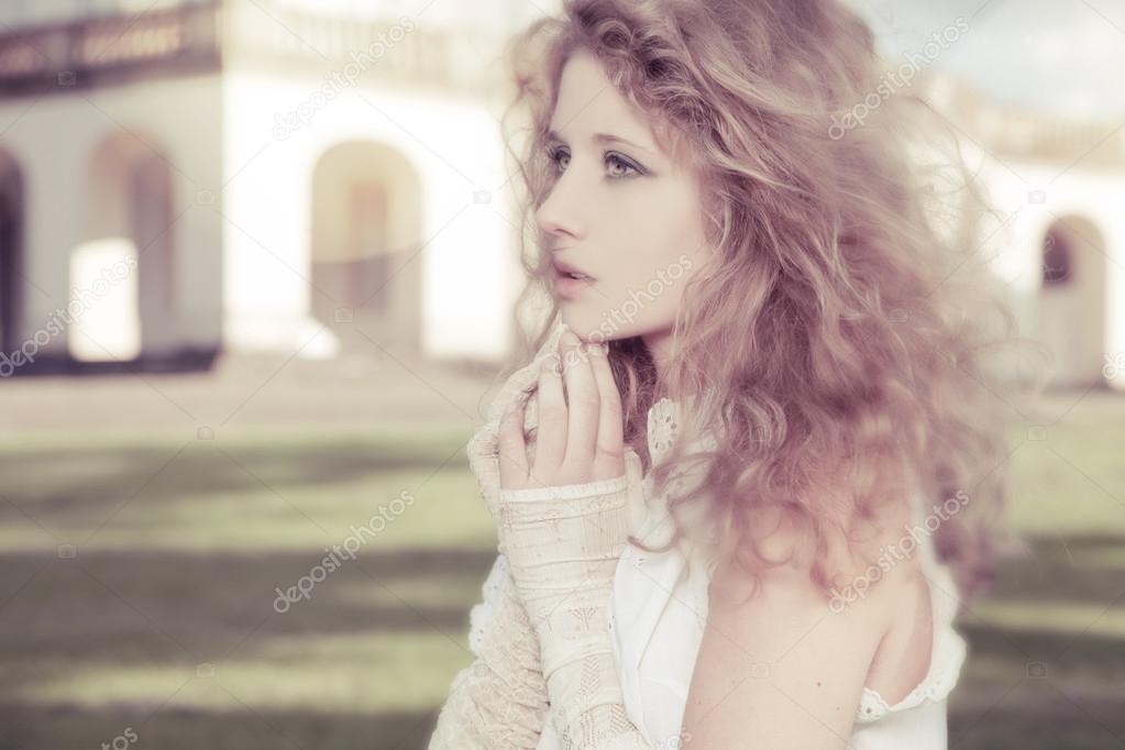 Beautiful woman outdoor portrait in front of a castle