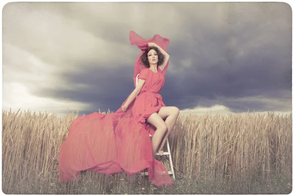 Beautiful woman in red dress background — Stock Photo, Image