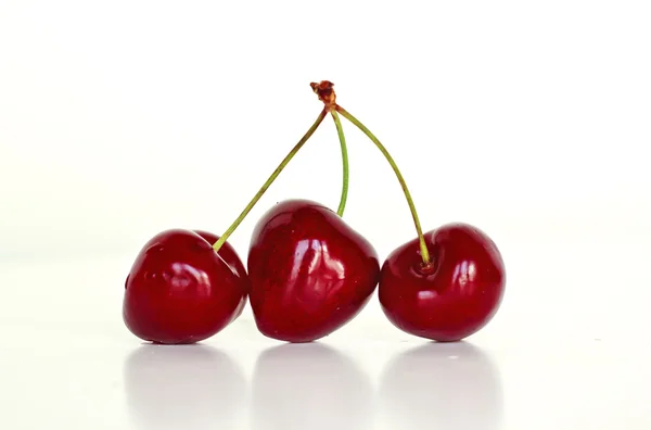 Three delicious red and sweet cherries — Stock Photo, Image