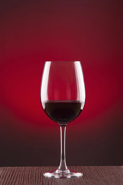 Glass of wine over red background — Stock Photo, Image