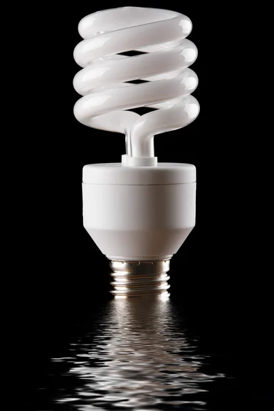 Energy saving lamp reflected in water — Stock Photo, Image