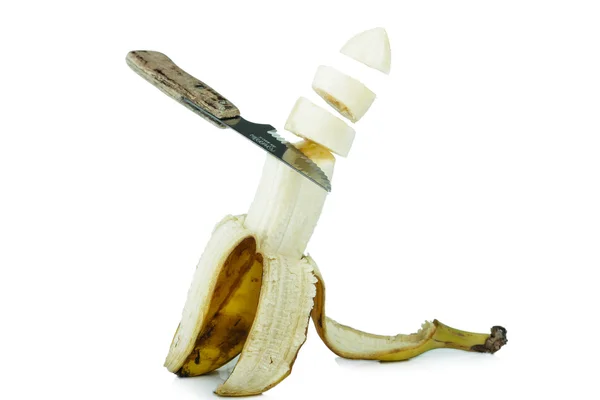 Knife cutting a banana — Stock Photo, Image