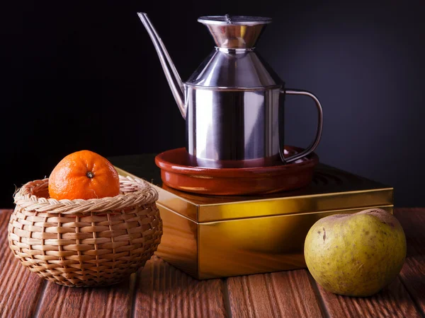 Still life with fruit and a jug of oil — Stock Photo, Image