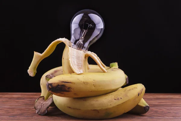 Bananas surrounding a bulb — Stock Photo, Image