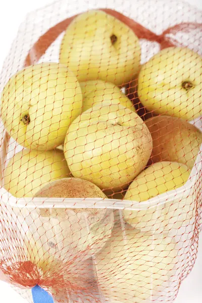 Apricots in a mesh — Stock Photo, Image