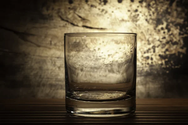 Glass back lit with grunge background — Stock Photo, Image
