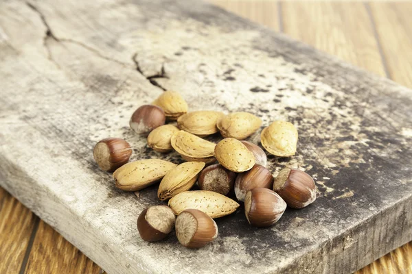 Nuts on wood — Stock Photo, Image