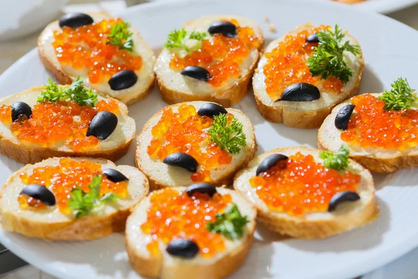 Caviar and olive on bread — Stock Photo, Image