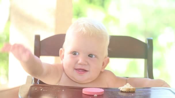 Baby kloppen op hoge stoel — Stockvideo