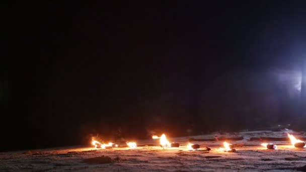 Fire fans lay on the sand — Stock Video