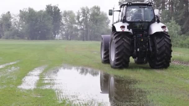 Trekker rijdt op veld — Stockvideo