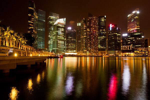Singapore business district in the night time with water reflections