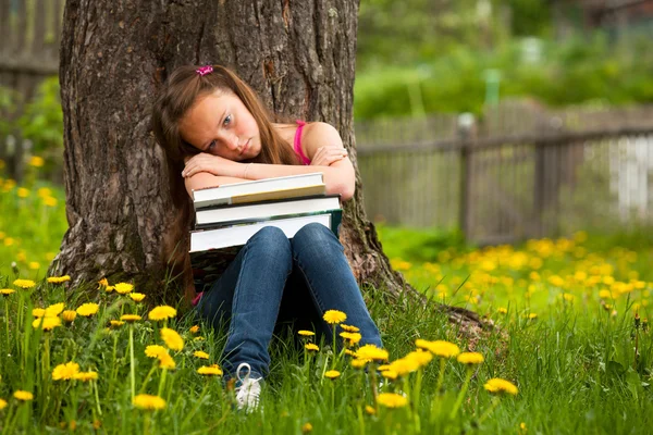 Tired school girl in the park — Stock Photo, Image