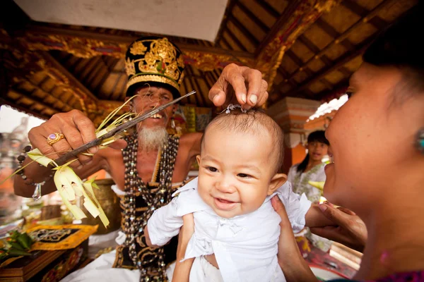 BALI, INDONESIA - 28 DE MARZO: El niño no identificado durante las ceremonias de Otón es la primera ceremonia para el bebé en la que se le permite tocar el suelo el 28 de marzo de 2012 en Bali, Indon. — Foto de Stock