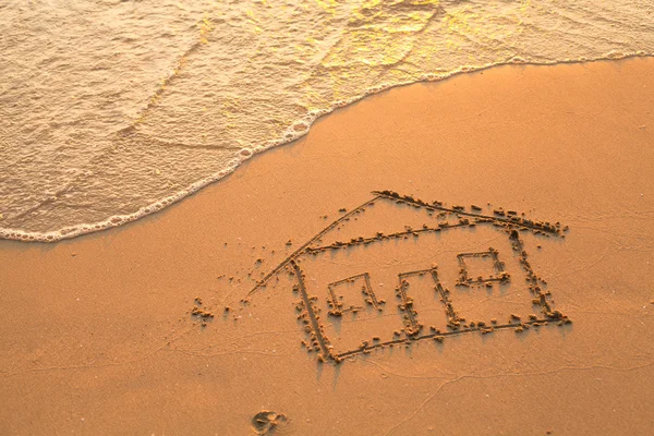 Photo conceptuelle : une maison peinte sur sable de plage — Photo