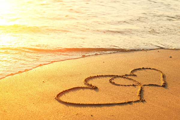 Hearts drawn on the sand of a beach