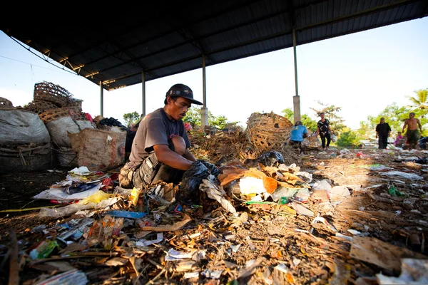 Bali, Indonesië worden-april 11: armen van java eiland werken in een opruiming op de stortplaats op 11 april 2012 op bali, Indonesië. Bali geproduceerd dagelijks 10.000 kubieke meter van afval. — Stockfoto