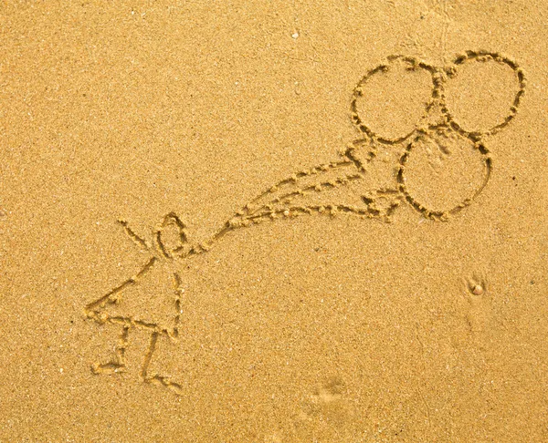 Drawing on the sand: a child with balloons. — Stock Photo, Image